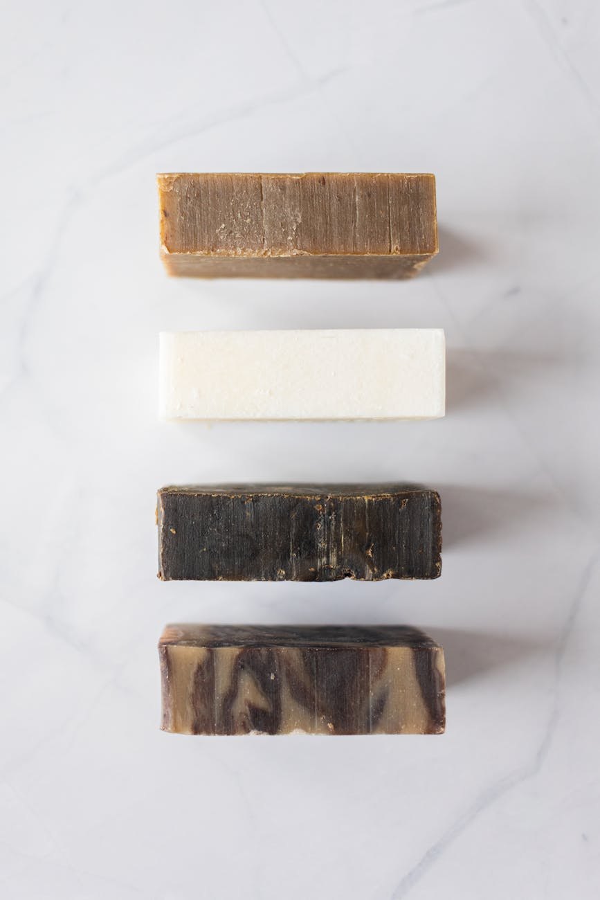 Handmade soap and bath products arranged in natural light studio setting